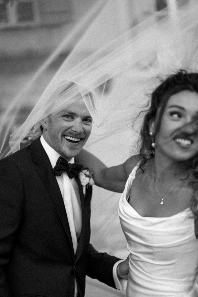 Black and white newlyweds walking through guests, joyful wedding celebration France