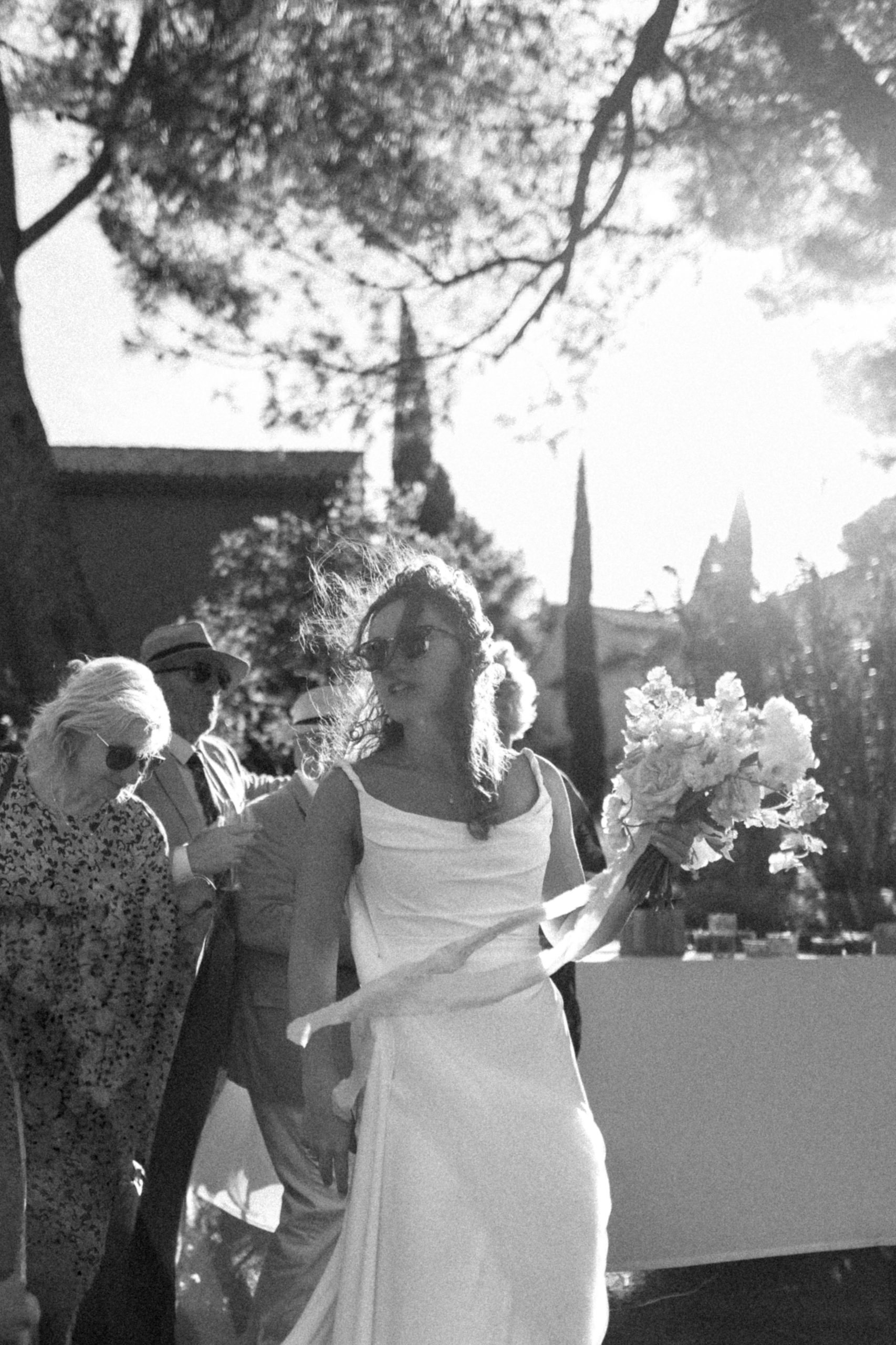 bride in Provence backlit by sunlight, wind in dress, natural wedding moment invisible direction